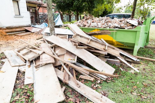 Construction site with builders clearing waste in Manor Park